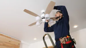 Licensed electricians installing a ceiling fan in a Brisbane home
