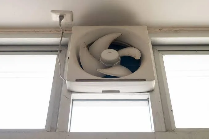 Licensed electricians installing an exhaust fan in a Brisbane bathroom